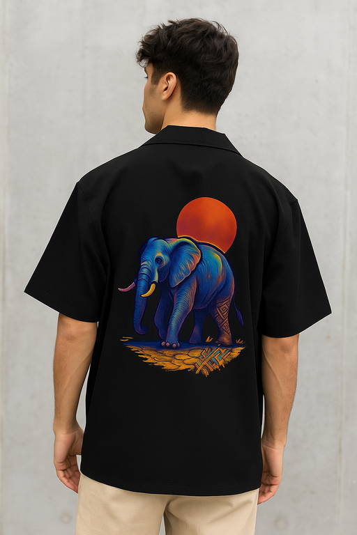 male model wearing Elephant walking under the blazing sun on back of a black oversized luxe cotton Shirt