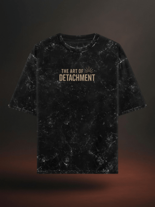 Black acid wash oversized t-shirt with 'The Art of Detachment' quote, perfect for spiritual journeys.
