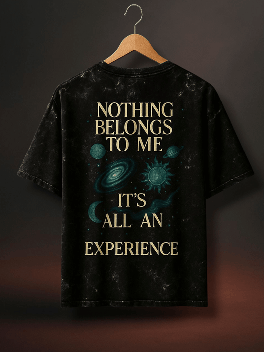 Black acid wash oversized t-shirt featuring cosmic design and inspiring quote about experience.